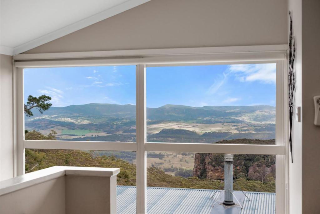 a window with a view of a mountain view at Currawong in Blackheath