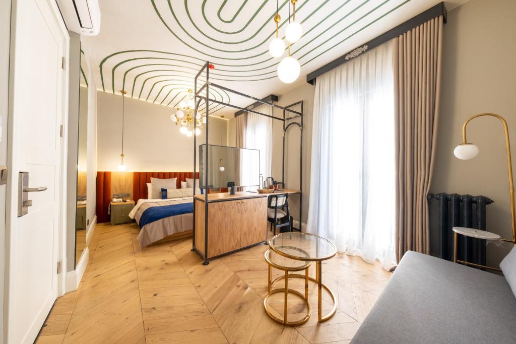 a bedroom with a bed and a table in a room at Hotel Balo in Istanbul