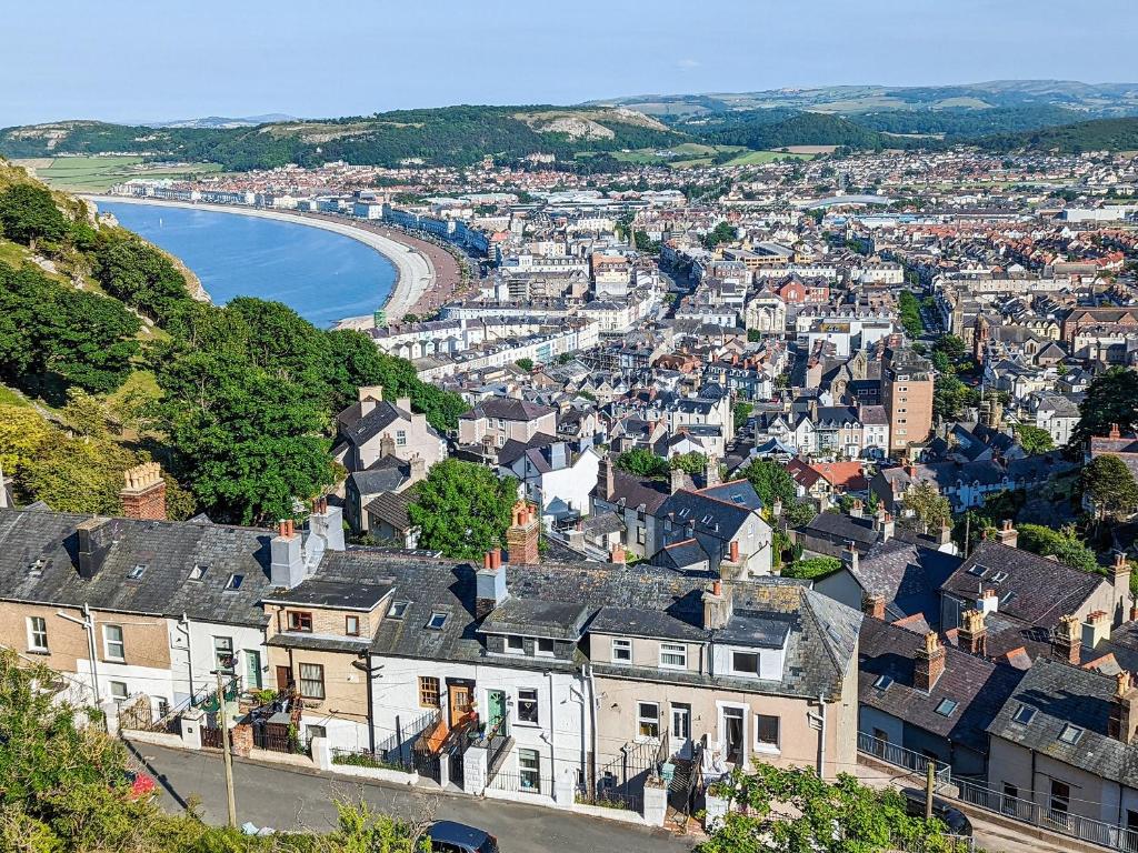 an aerial view of a city with houses and a river at White Cottage in Llandudno