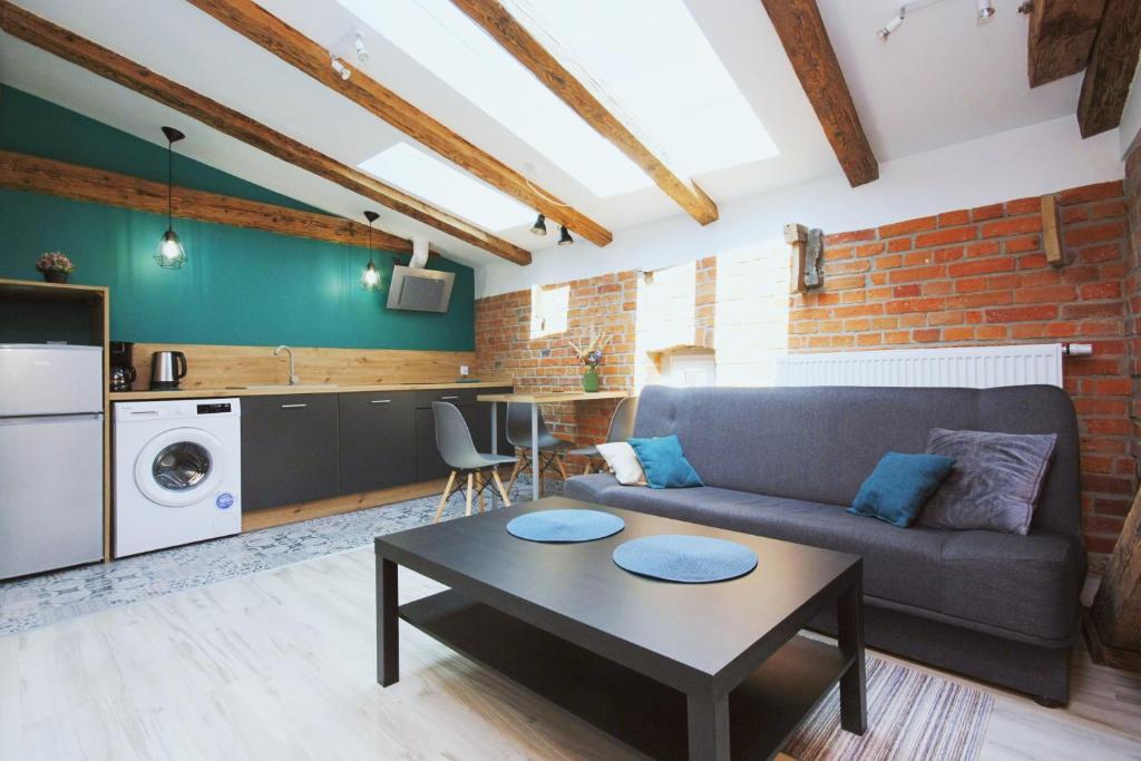 uma sala de estar com um sofá e uma mesa em Apartamenty na Starym Mieście em Gliwice