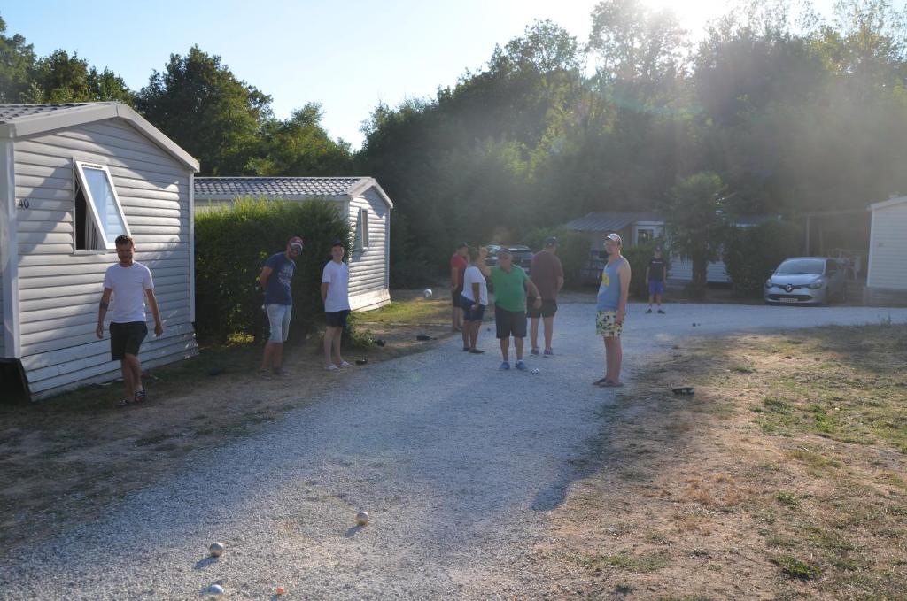 a group of people standing next to a building at Camping La Venise Du Bocage in Nesmy