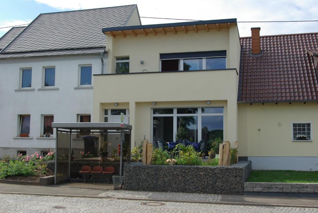 a house with a garden in front of it at Ferienhaus Sonnenaufgang in Nohfelden