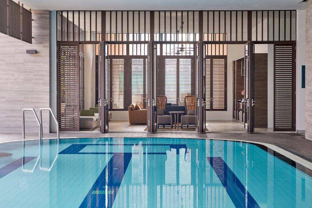 a large swimming pool in a house at Somerset Park Suanplu Bangkok in Bangkok