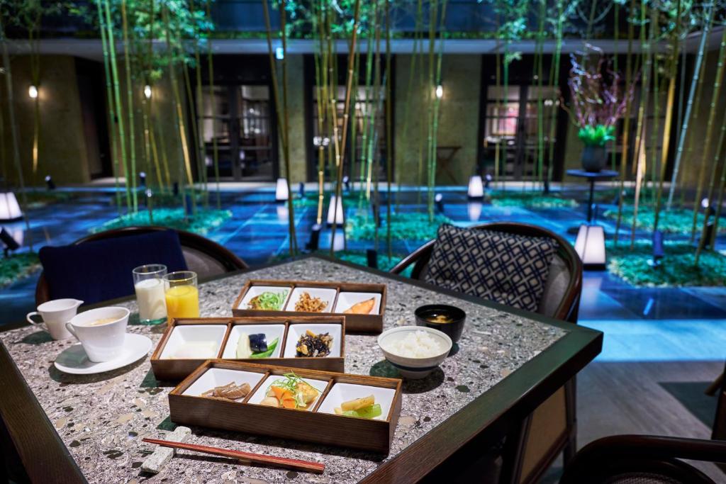 a table with plates of food on top at Dhawa Yura Kyoto - Banyan Group in Kyoto