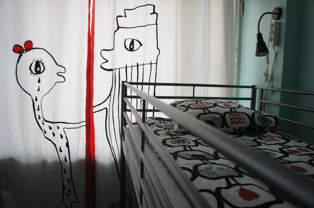 - une chambre avec un lit orné d'un dessin mural dans l'établissement SweetDream Guesthouse, à Helsinki