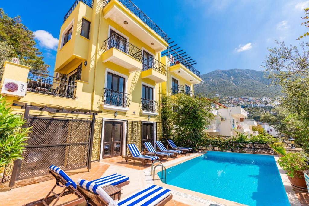a villa with a swimming pool in front of a building at Villa Vista Mare in Kalkan