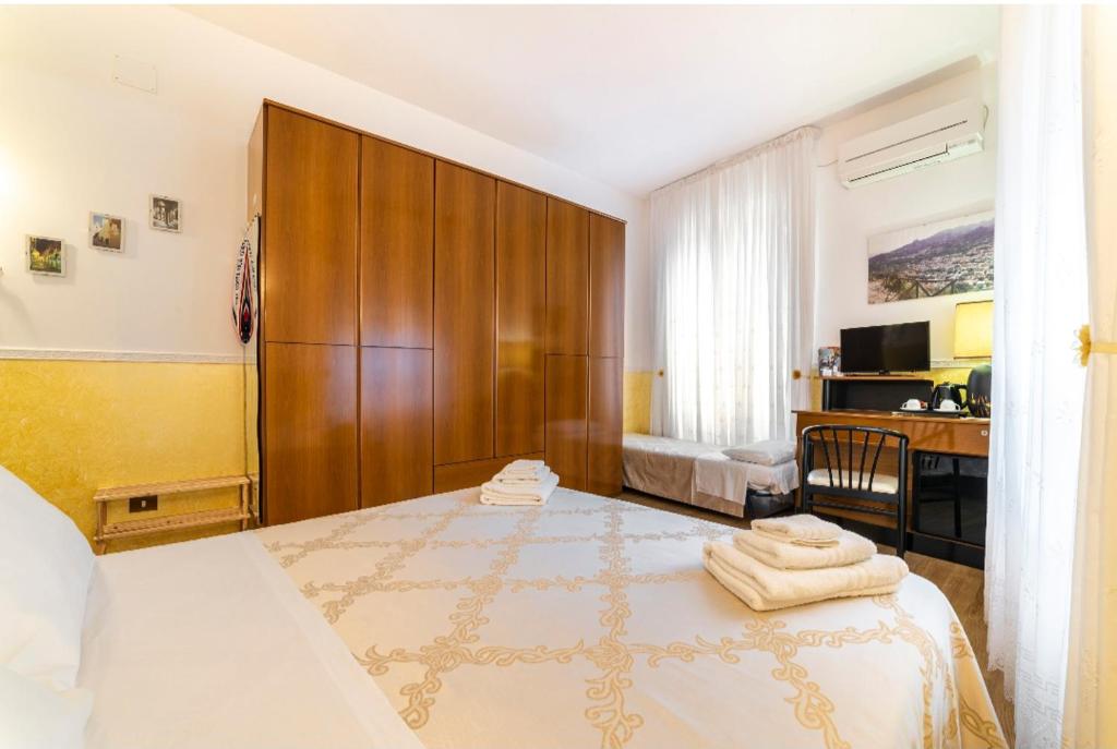 a bedroom with a large bed and a desk with a desk at B&B Borgo Antico in Cava deʼ Tirreni