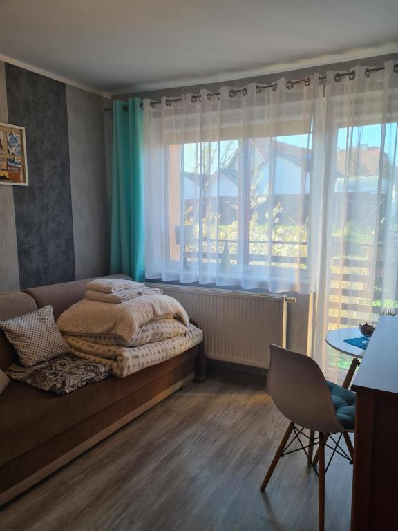 a bedroom with a bed and a large window at DOM SABINA in Krynica Morska