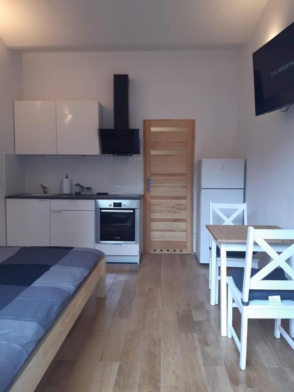 a kitchen with a bed and a table in a room at Apartament Klimt 1 in Bielsko-Biała