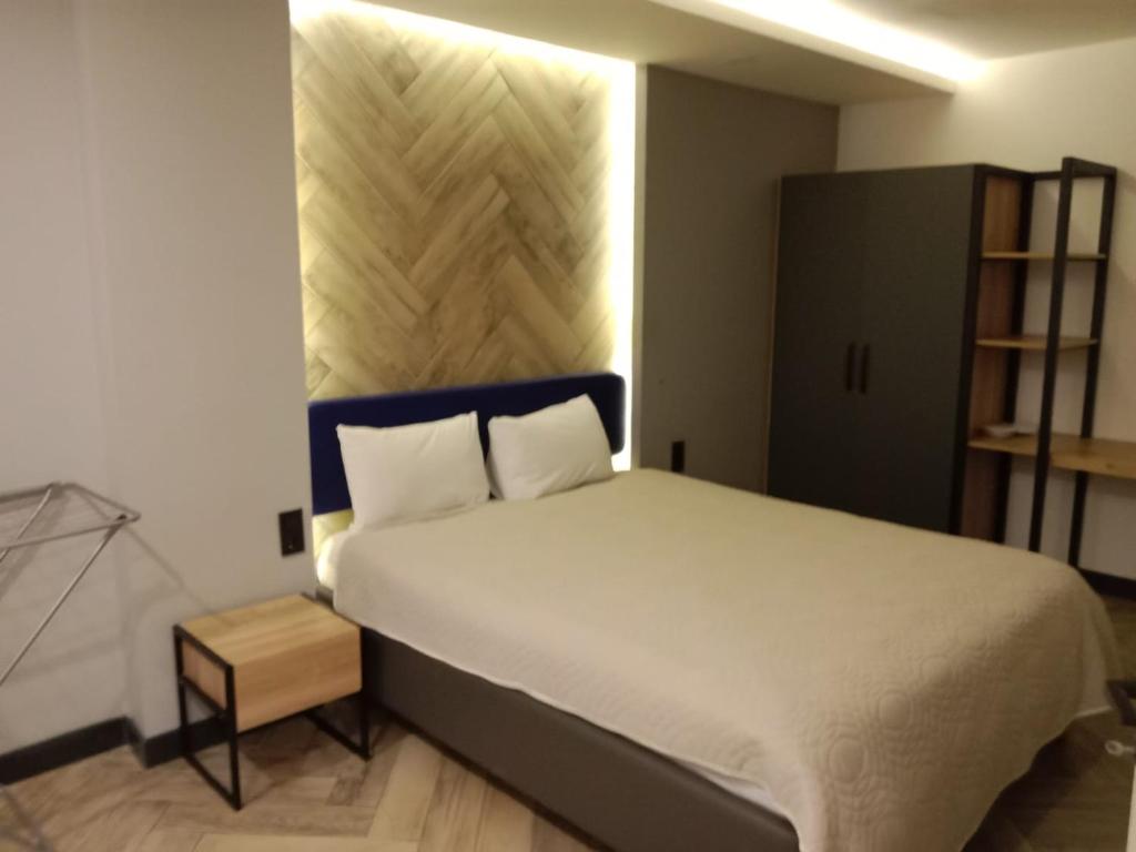 a bedroom with a large white bed and a shelf at Meyde Boutique Suites in Antalya