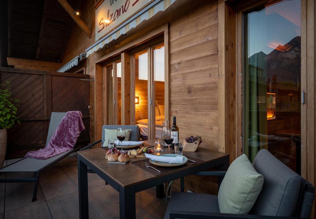 a dining room with a table and chairs on a balcony at SALZANO Apartments in Interlaken