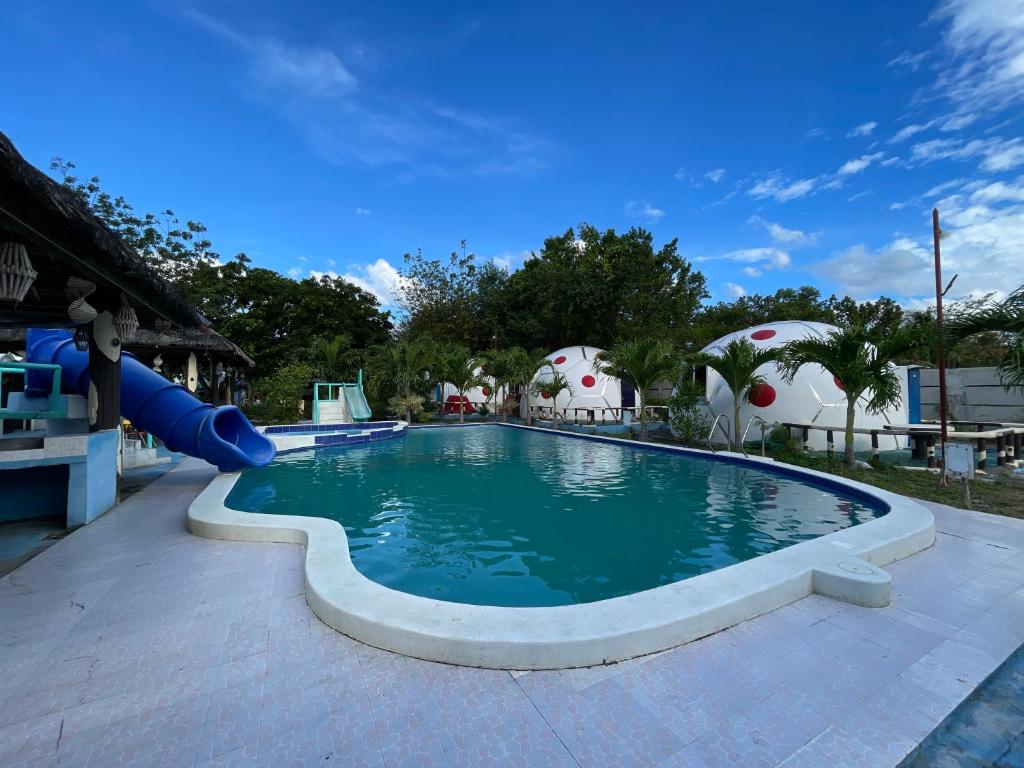 a pool at a resort with a slide at Binubusan Beach Hotel and Resort in Lian