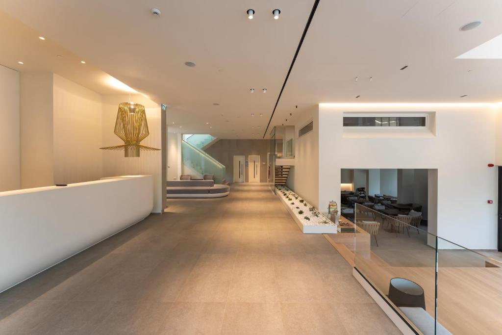 a hallway of a building with white walls and wood floors at Emmantina Hotel in Athens