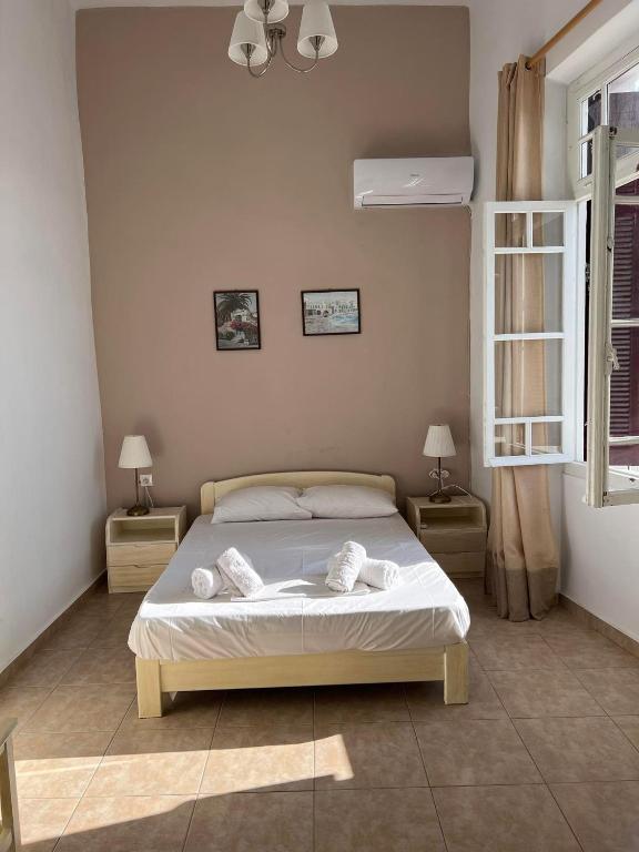 a bedroom with a bed with towels on it at Tinos Central Perfection in Tinos