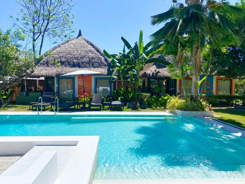 a swimming pool in front of a house at Villa Kasadya in Panglao Island