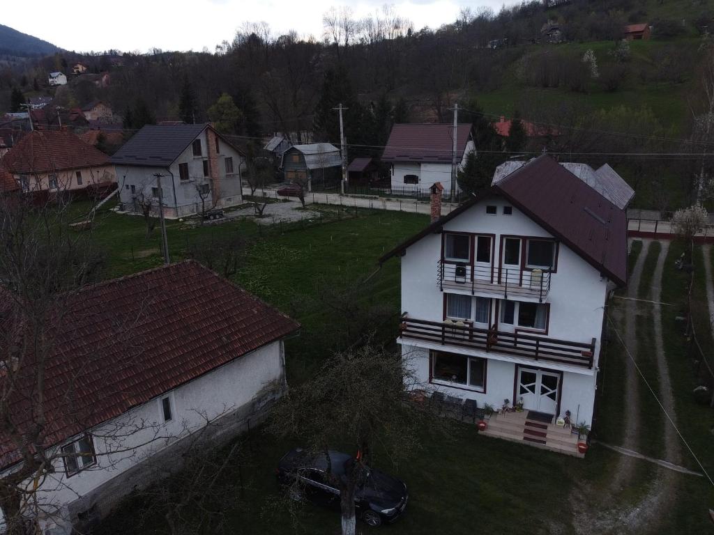 an aerial view of a white house in a village at Pensiunea Constanta in Bran