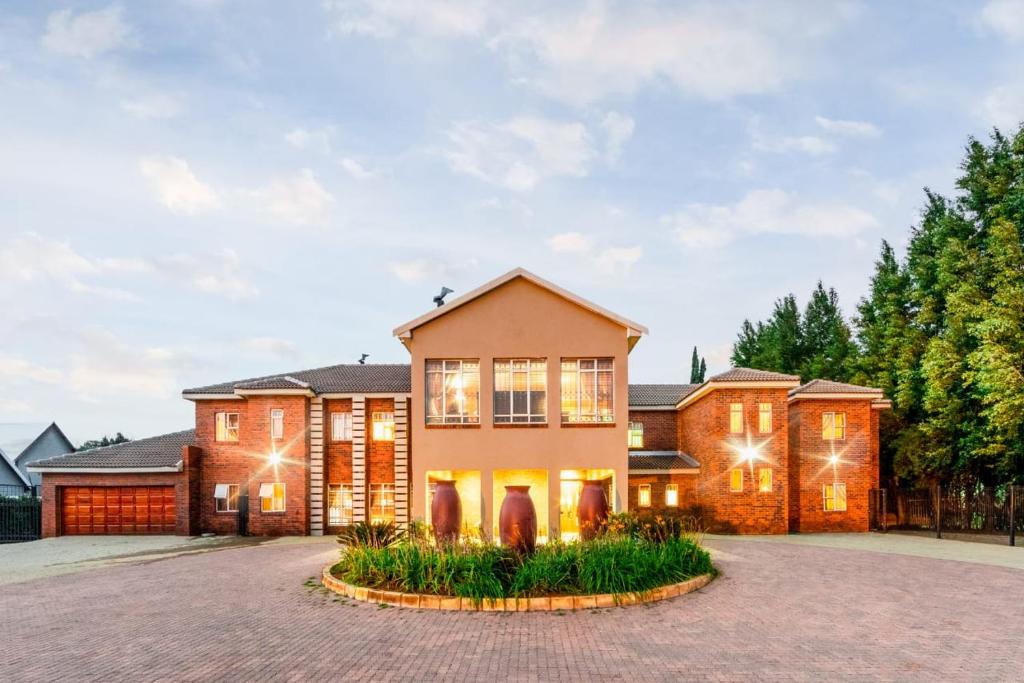 a large house with a driveway at ARK Guesthouse in Potchefstroom