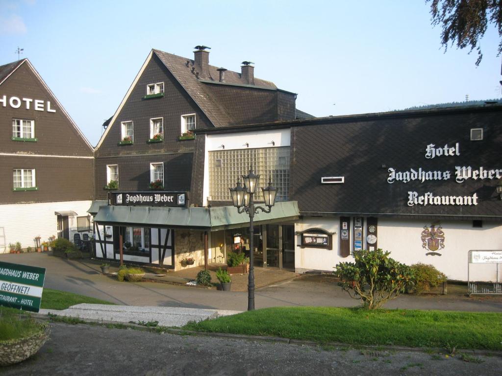 a large building with a sign in front of it at Jagdhaus Weber in Herscheid