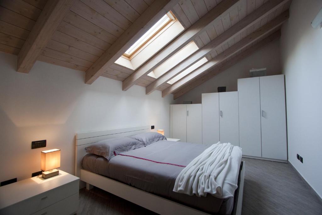 a bedroom with a large bed and a skylight at La Corte del Gallo in Gallarate