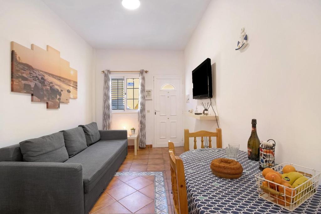 a living room with a couch and a table at Las Arenas bajo in La Mareta