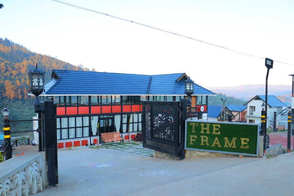 a large building with a sign in front of it at The Frame Resorts Ooty in Ooty