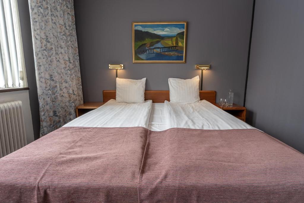 Postel nebo postele na pokoji v ubytování Hotell Villa Sparta