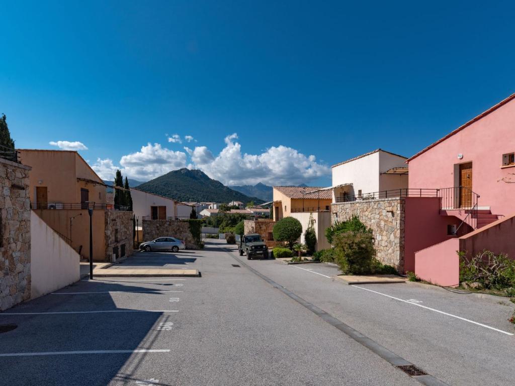 a street in a town with mountains in the background at Holiday Home Chez Béatrice et Pascal by Interhome in Belgodère