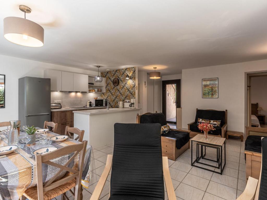 a kitchen and a living room with a dining table at Holiday Home Chez Béatrice et Pascal by Interhome in Belgodère