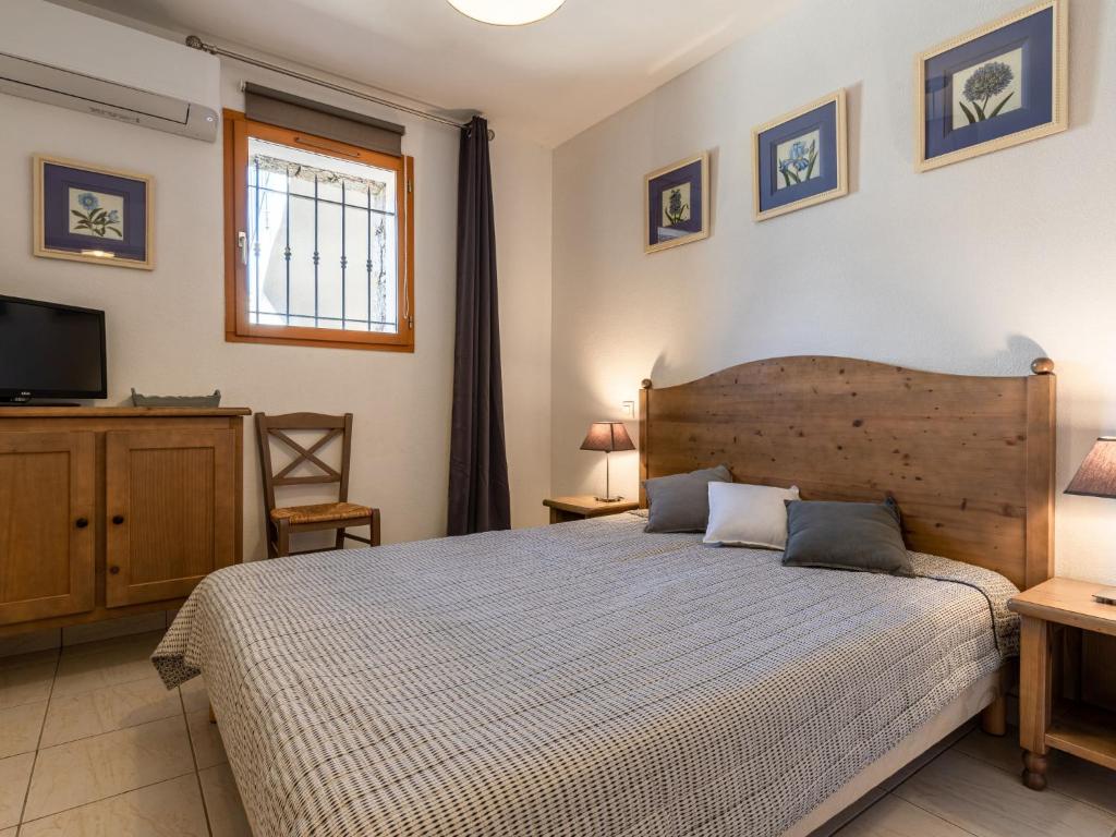 a bedroom with a large bed and a television at Holiday Home Chez Béatrice et Pascal by Interhome in Belgodère