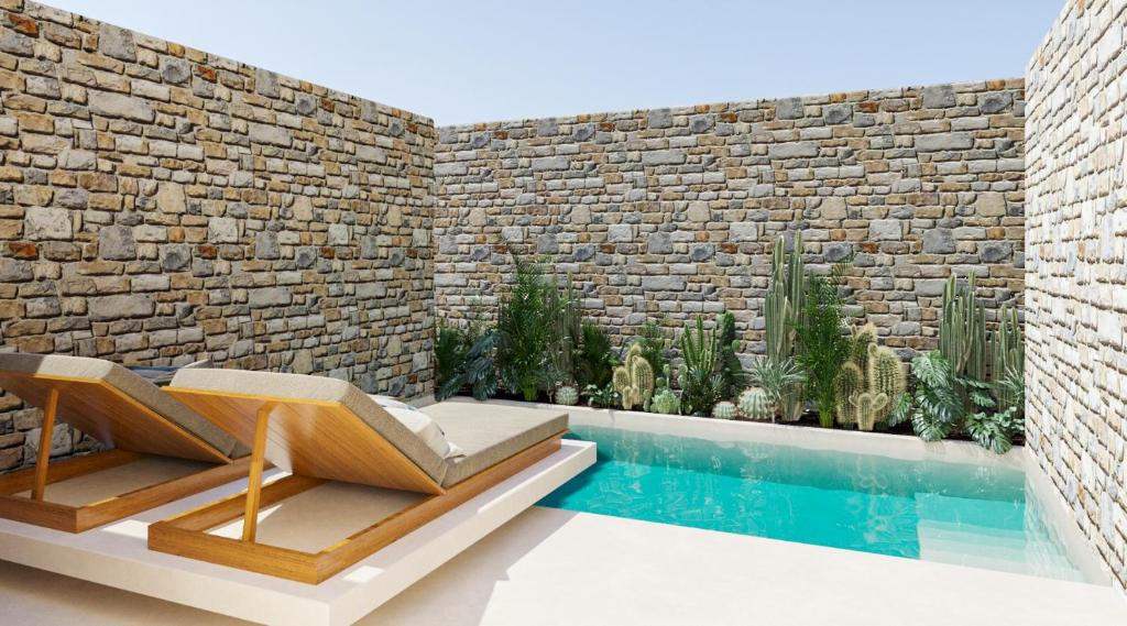 a room with a swimming pool and a brick wall at Princess Luxury Suites Adults Only - Princess Hotels Collection in Agia Anna Naxos