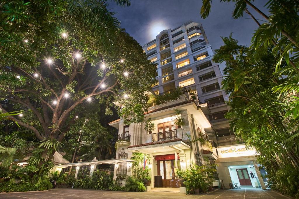 a building in front of a tall building at Orchid Garden Suites in Manila