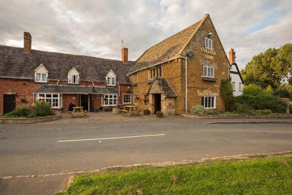 a large brick building with a building with a street at College Arms in Stratford-upon-Avon