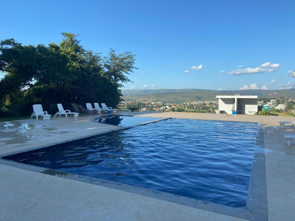 a large swimming pool with chairs at Casa em Escarpas do Lago in Capitólio