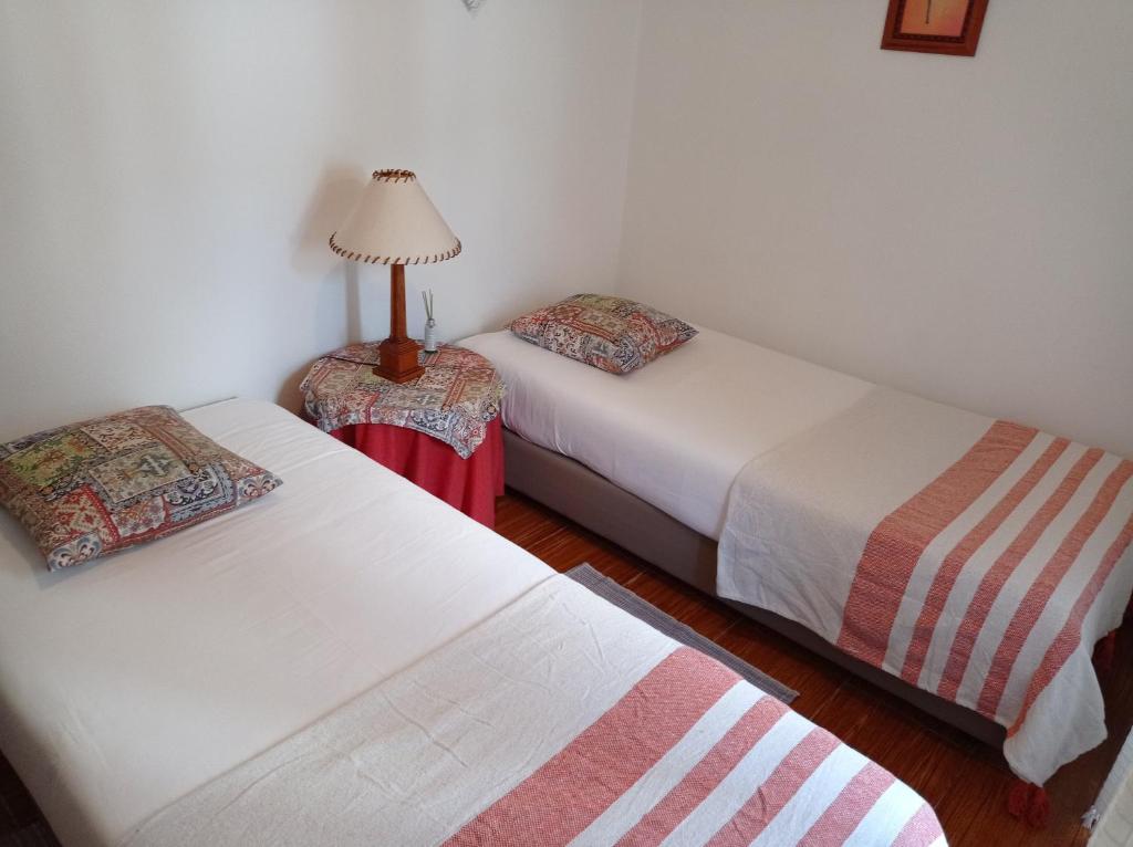 a room with two beds and a lamp in it at Apartamento 2 - Fundação de Veiros in Veiros