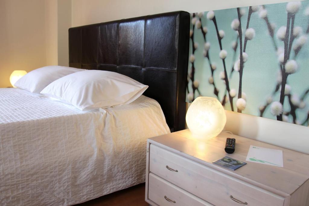 ポボア・デ・バルジンにあるRêve D'Orのベッドルーム1室(黒いヘッドボード付きのベッド1台、ナイトスタンド付)