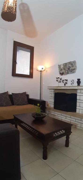 a living room with a couch and a coffee table at Golden Mountain in Anilio Pelion