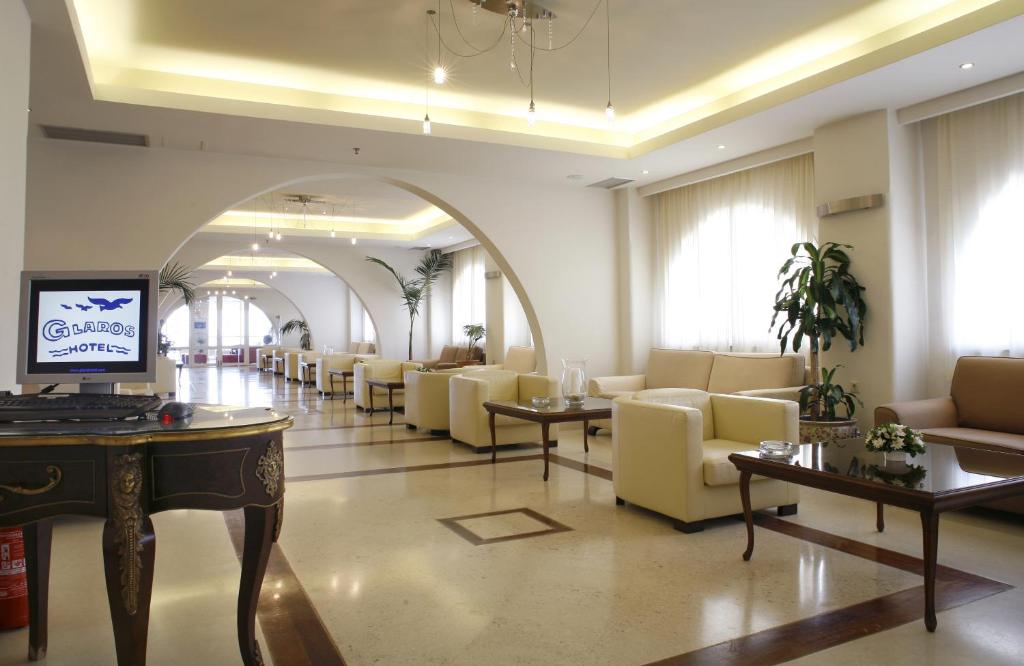 a lobby with a waiting room with couches and tables at Glaros Beach Hotel in Hersonissos