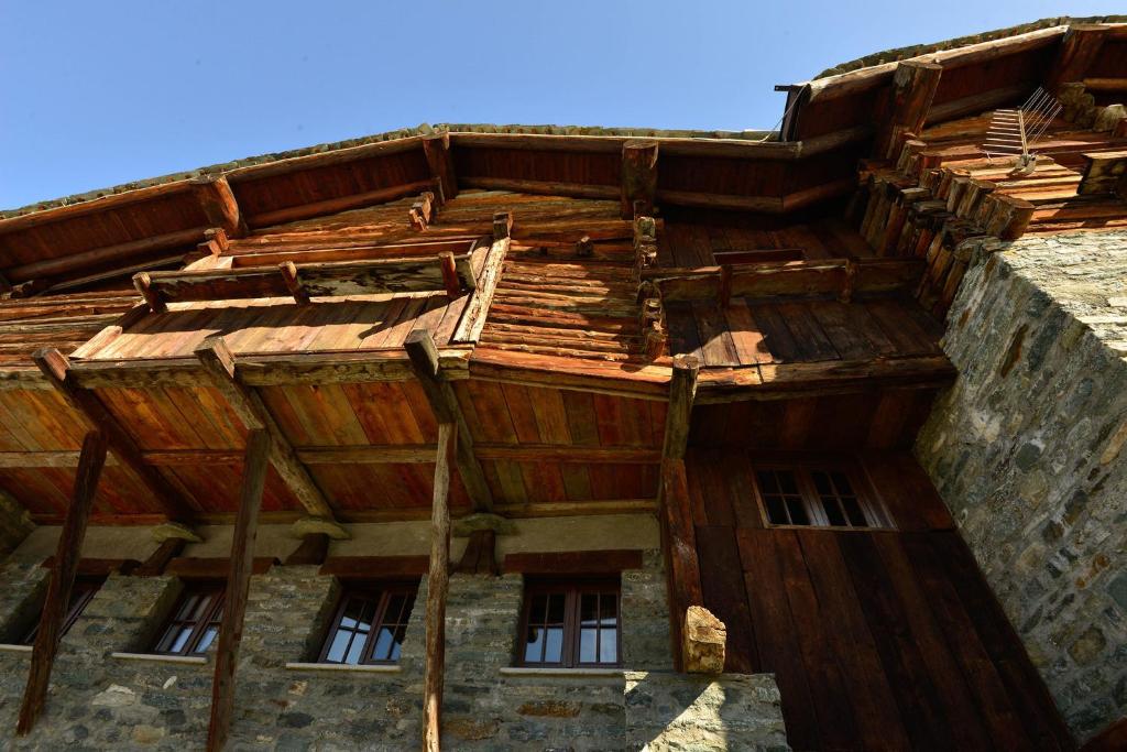 a building with a wooden roof on top of it at Rifugio Vieux Crest in Champoluc