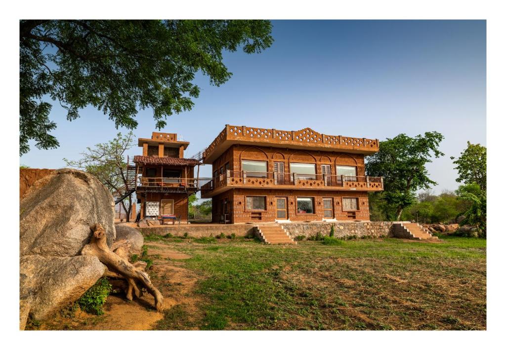 a large brick house with a tower on top of it at Chandera Kothi in Orchha