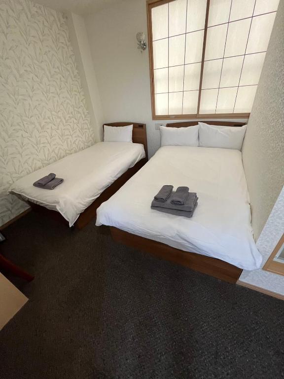 Postel nebo postele na pokoji v ubytování Allcomein Hotel Akihabara