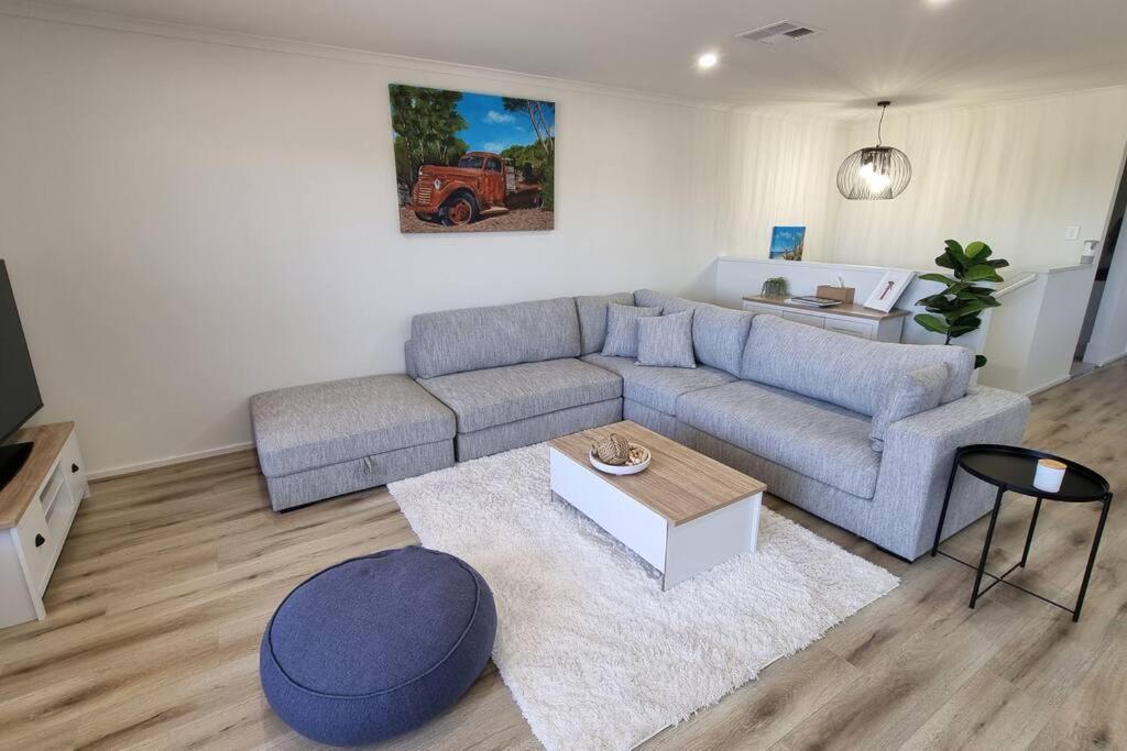 a living room with a couch and a table at The Bunker Normanville in Normanville