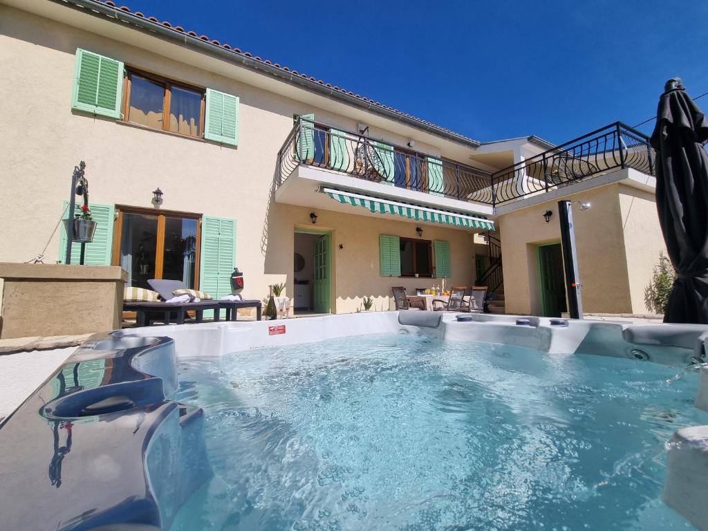 a swimming pool in the backyard of a house at Holiday house Villa Marea with jacuzzi in Crikvenica