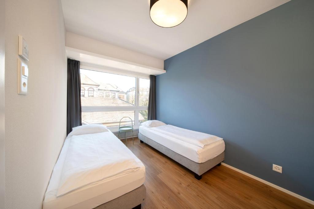 Letto o letti in una camera di Hotel by Hyve Basel