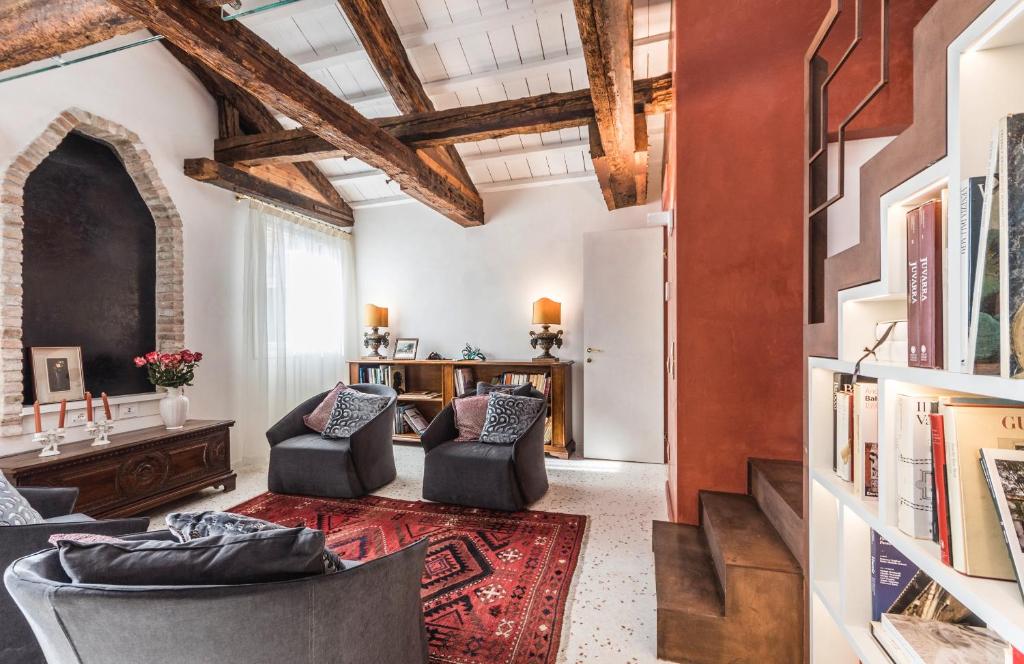 salon z 2 krzesłami i stołem w obiekcie Apartment Cà Brunilda-luxury penthouse with terrace w Wenecji