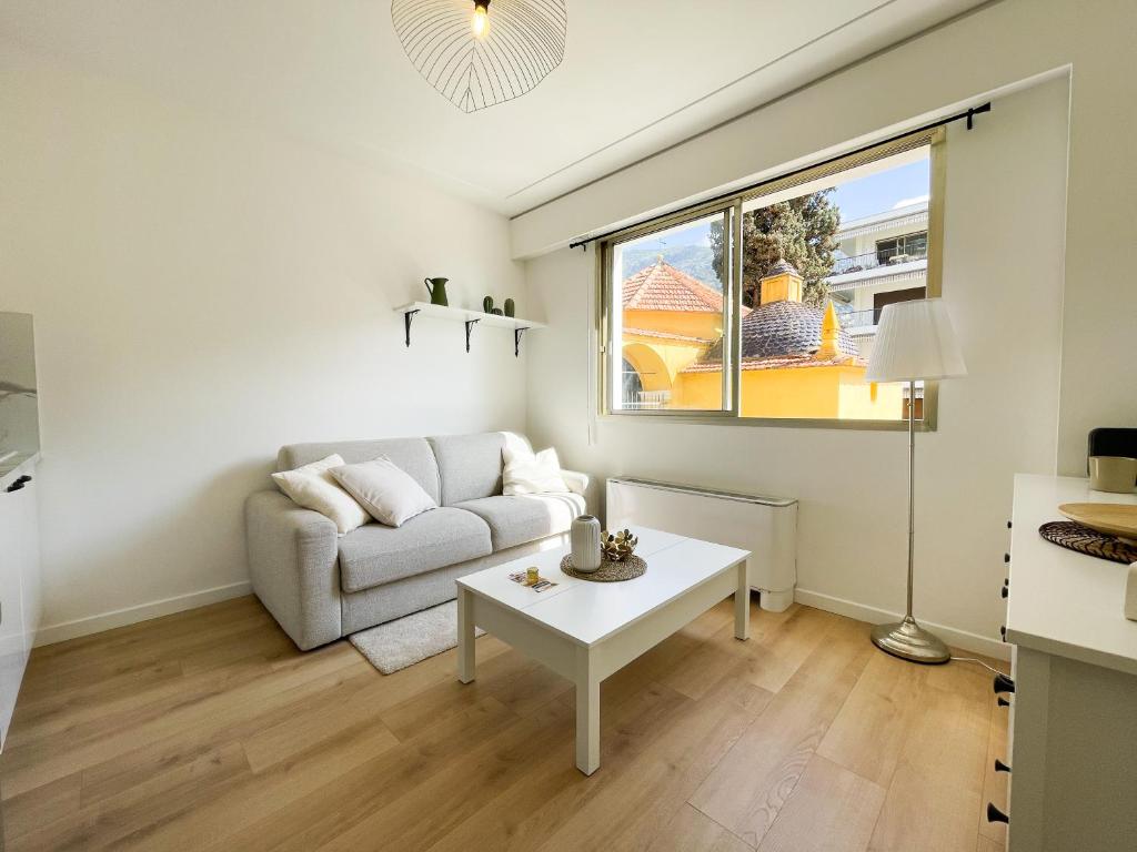 un salon avec un canapé et une table dans l'établissement Studio bord de mer 3, à Menton