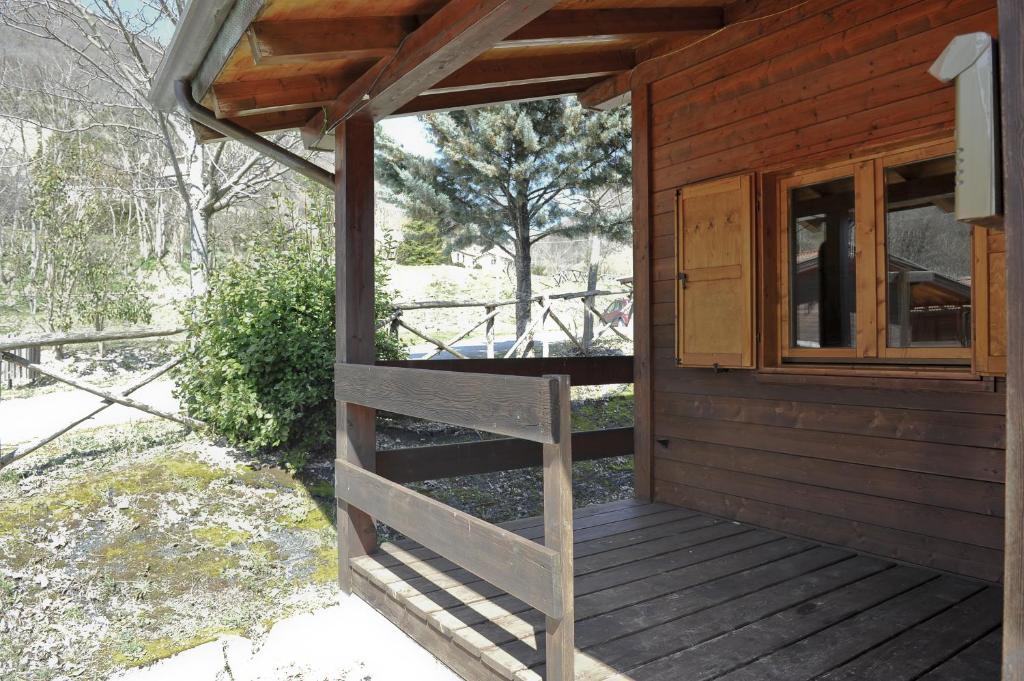 a porch of a wooden cabin with a window at Holiday Home Bagnara in Nocera Umbra