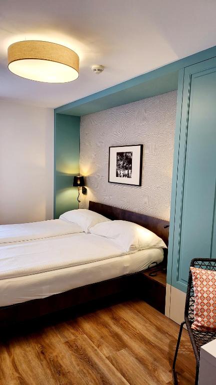 Voodi või voodid majutusasutuse Hotel Pestalozzi Lugano toas