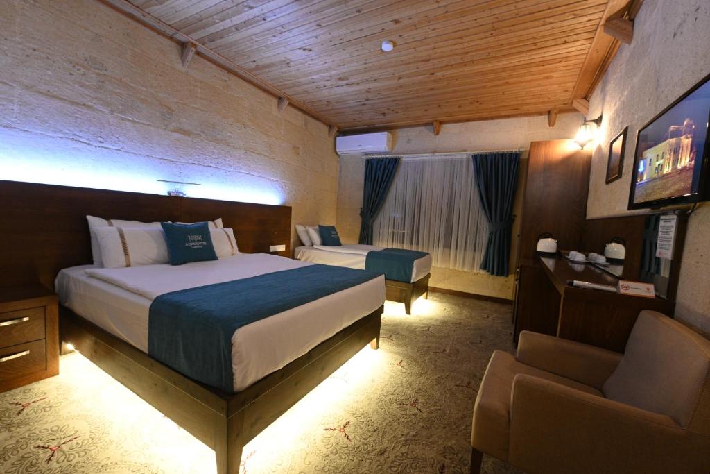 A bed or beds in a room at Aden Hotel Cappadocia