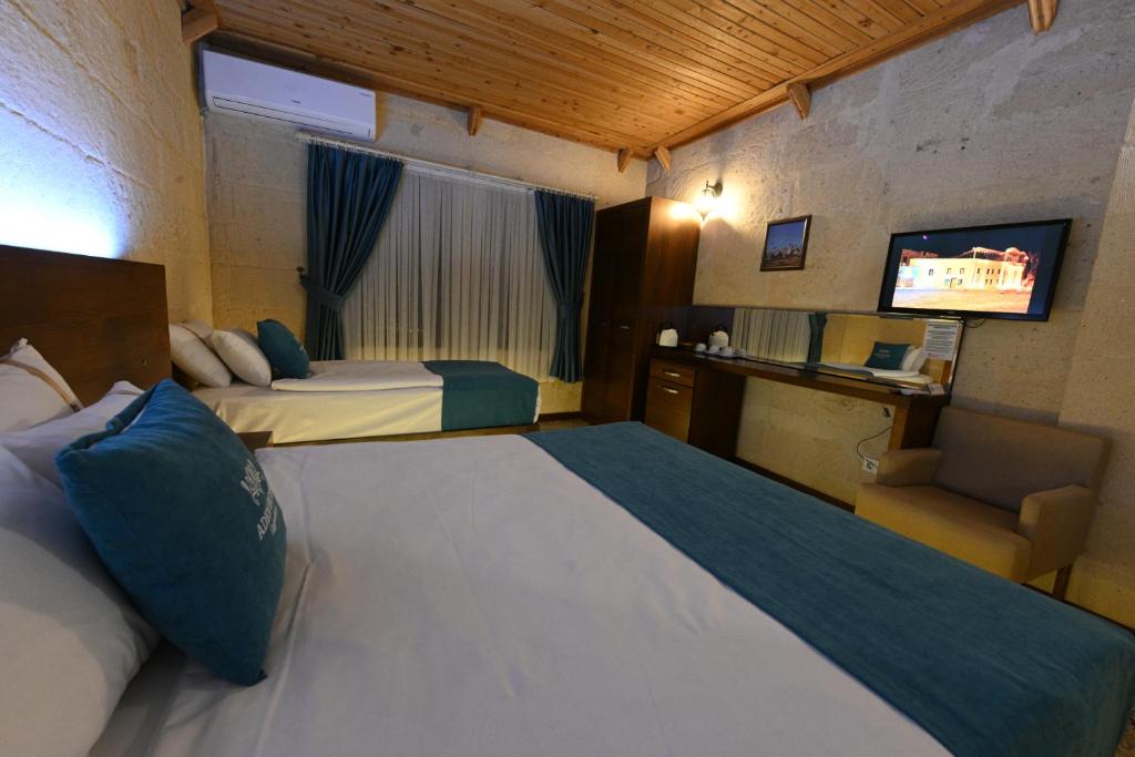A bed or beds in a room at Aden Hotel Cappadocia