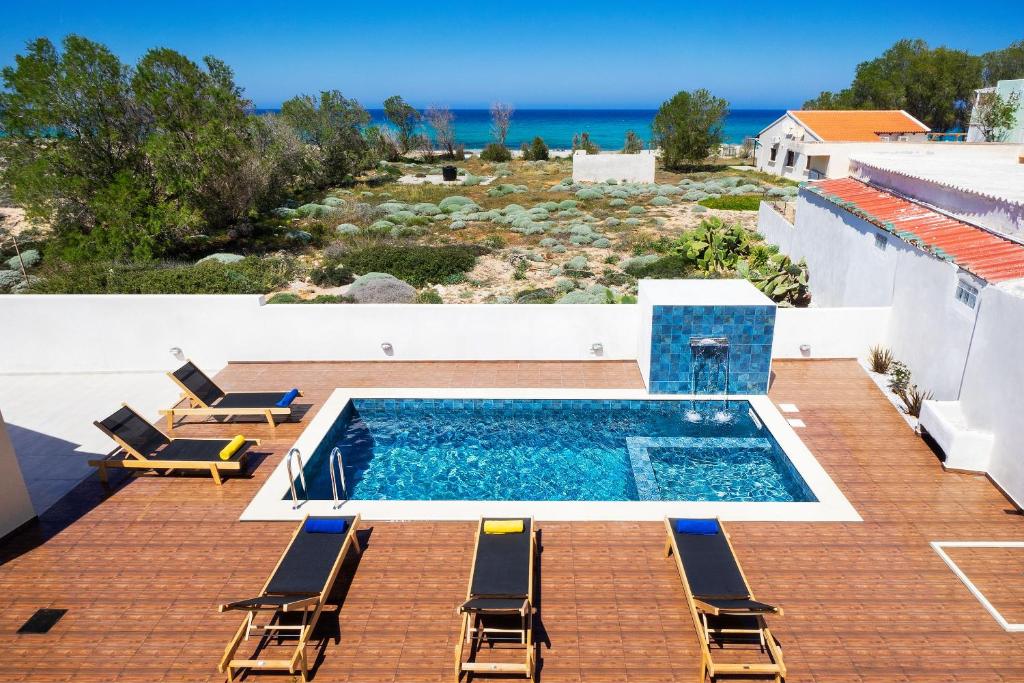 a swimming pool on the roof of a house at Villa Makisland With Sea View in Stavros
